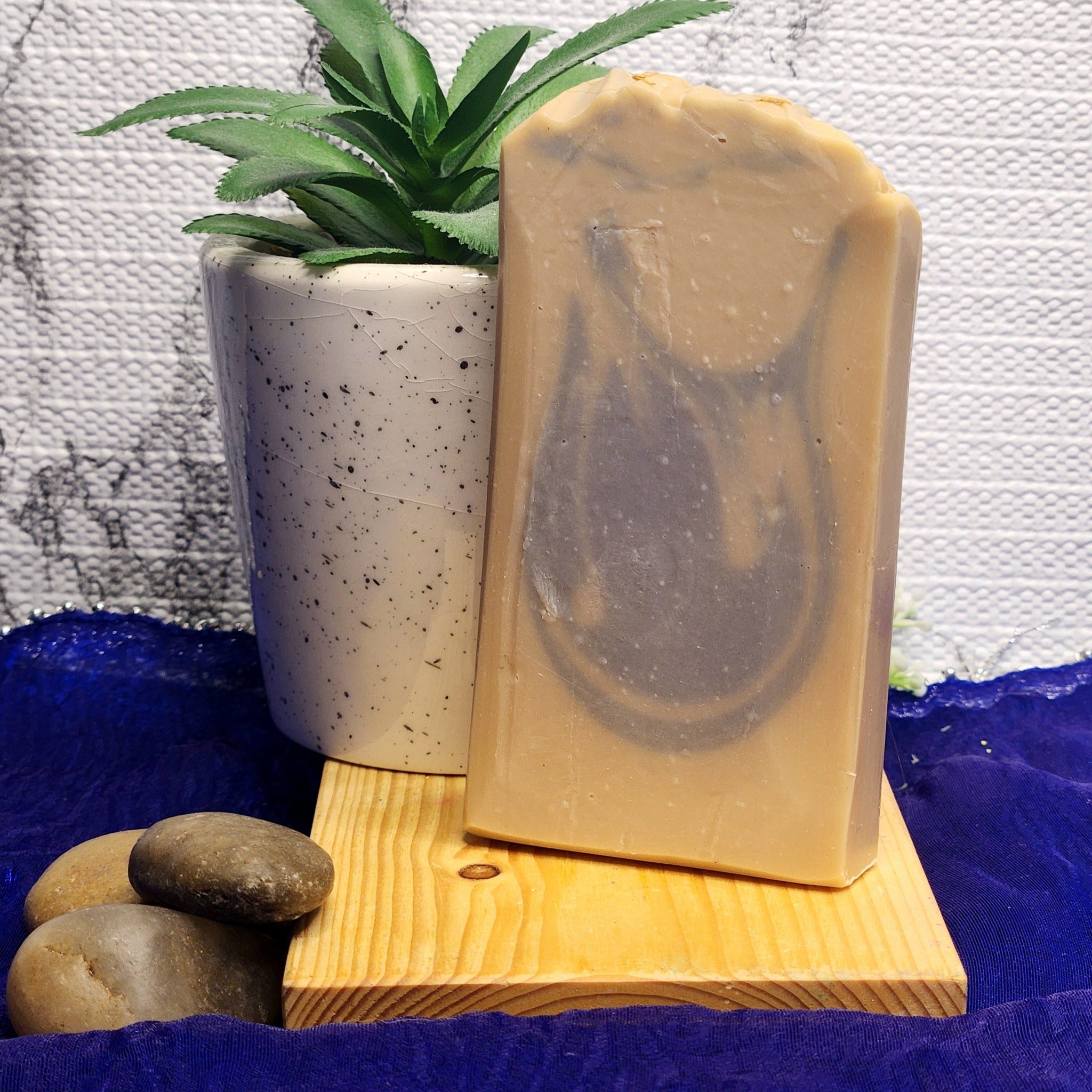 Blackberry & Buttercream soap is a blend of juicy berries with hints of peach and vanilla bean. This soap is a creamy light tan colour with a dull purple swirls. The top is textured and has a few dried blue cornflowers.